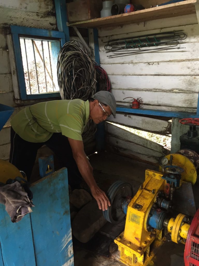 Headman of Long Lawen Village shows visitors the micro-hydro powerhouse