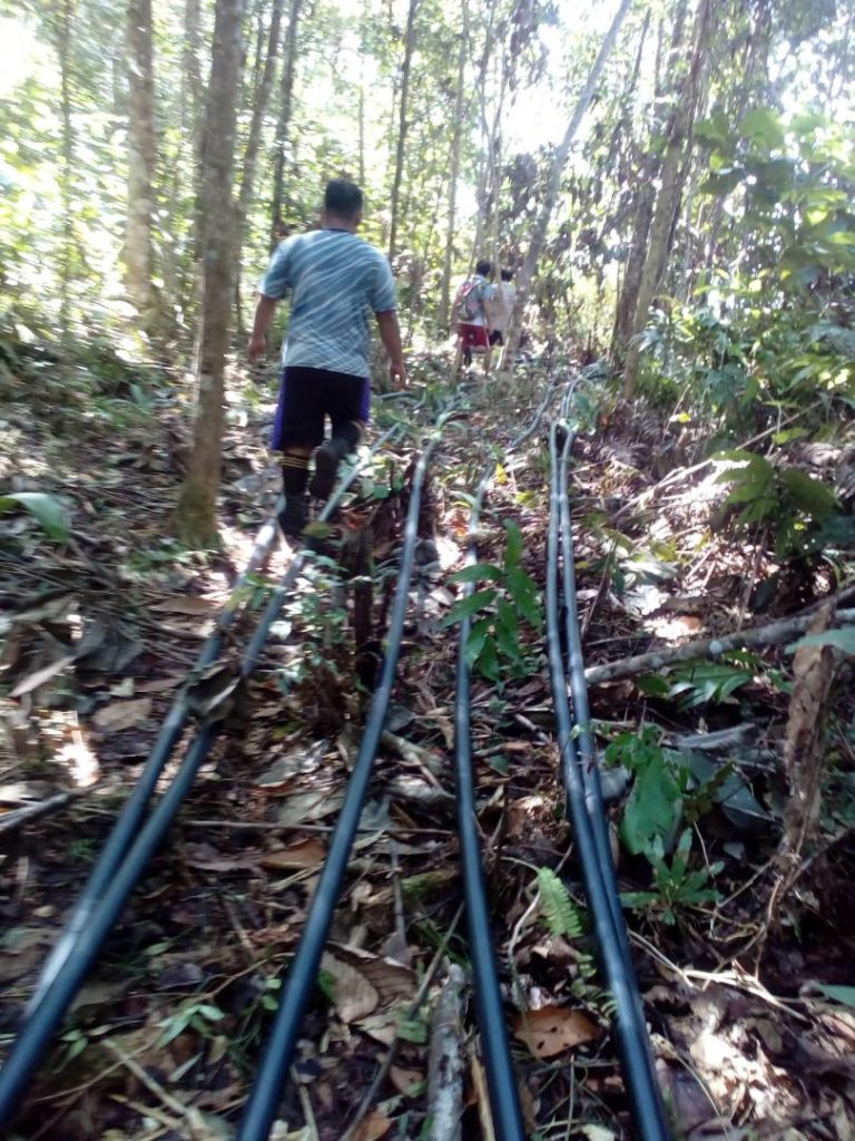 Laying piping for water system in Mangkadait, Sabah, Malaysia
