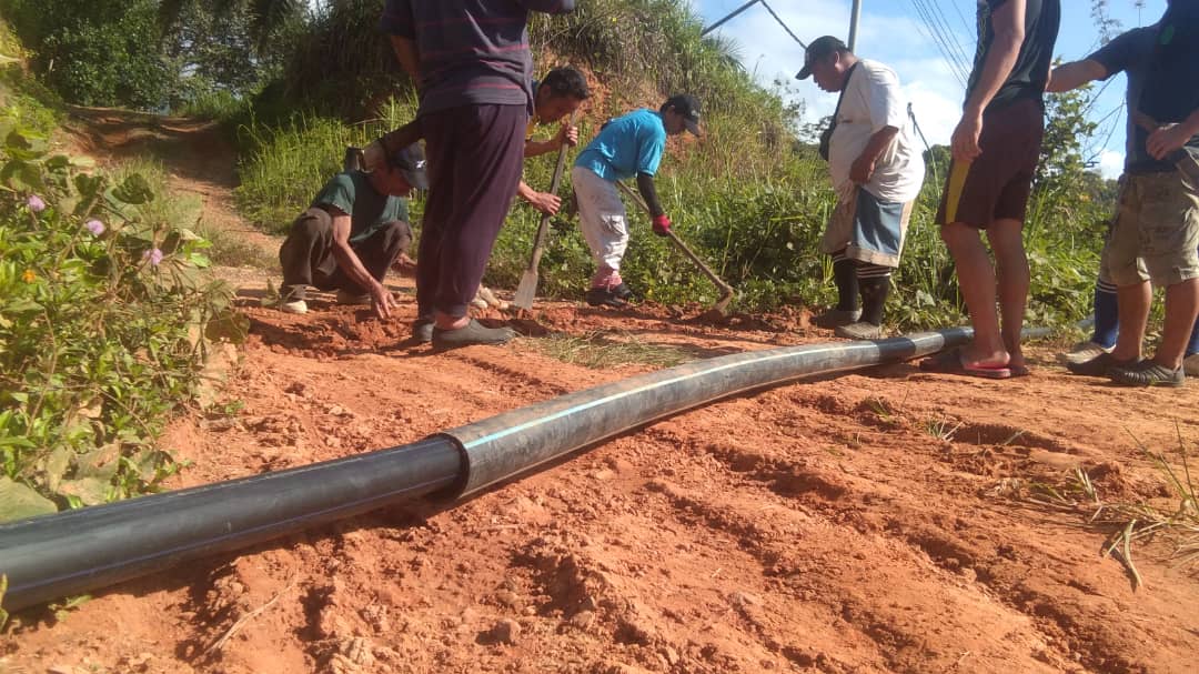 Villagers install the pipeline
