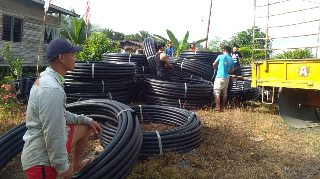 Villagers prepare to install the water pipeline.