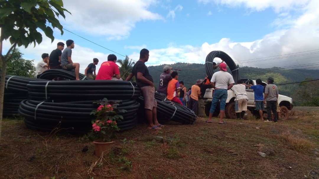 villagers prepare to install pipeline