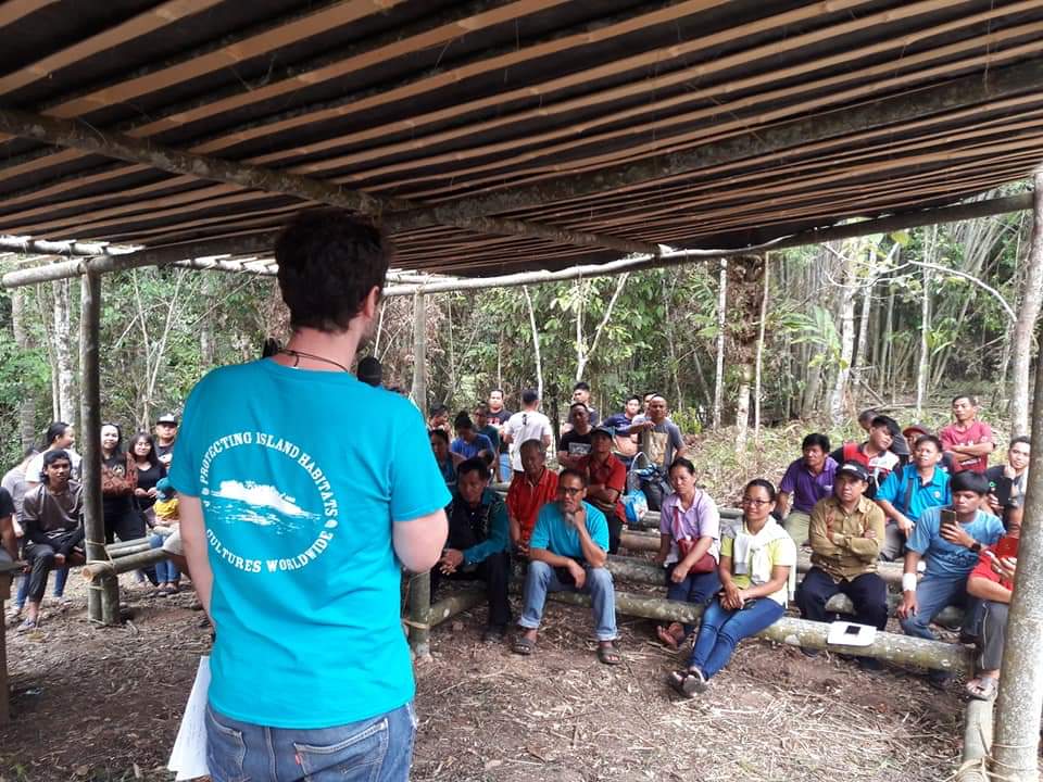 A Seacology representative meets with villagers in Borneo