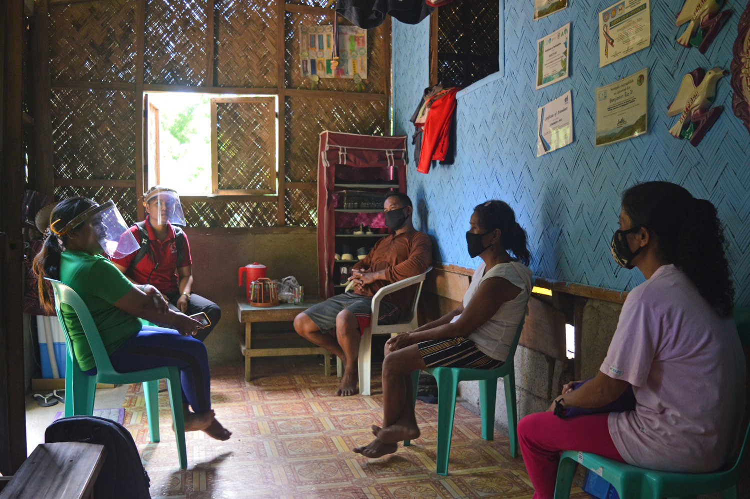 People meet in a room in Barangay Bogtong to discuss environmental projects