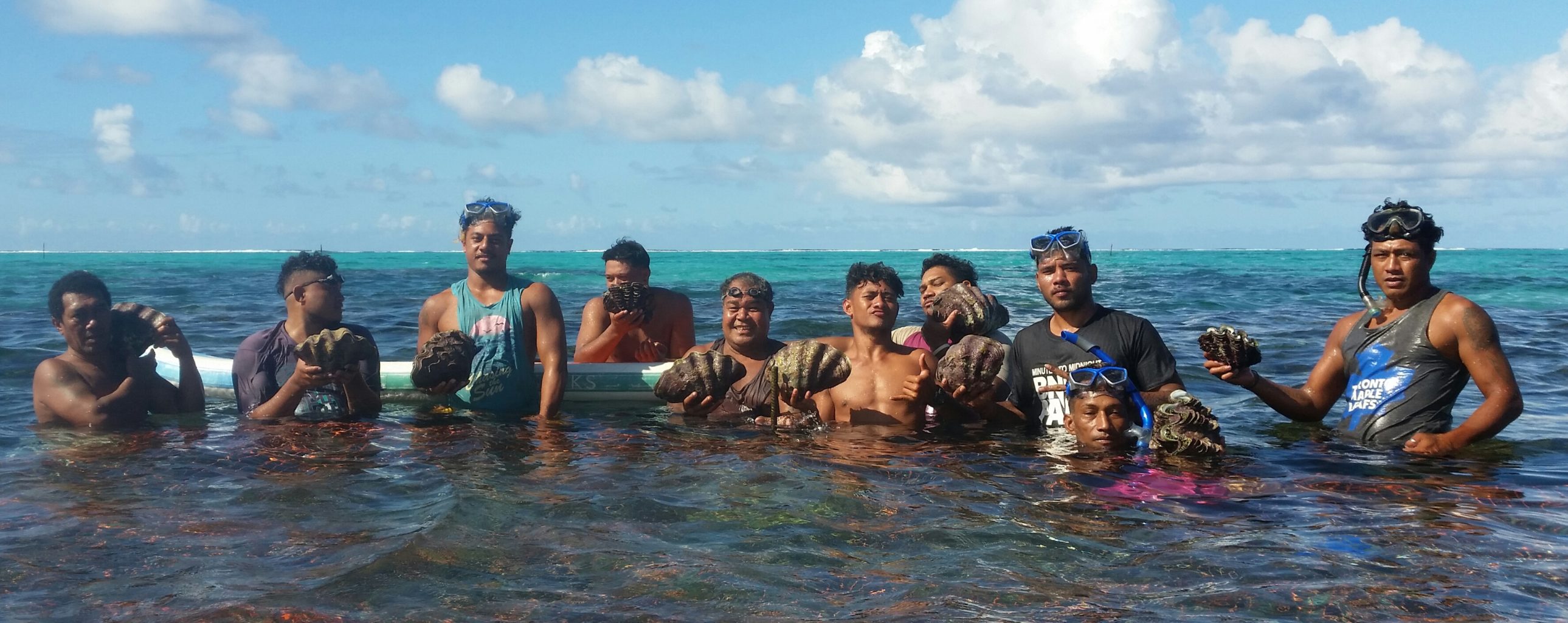 Mean from Setafao Saipipi Village, Samoa, hold giant clams in the water
