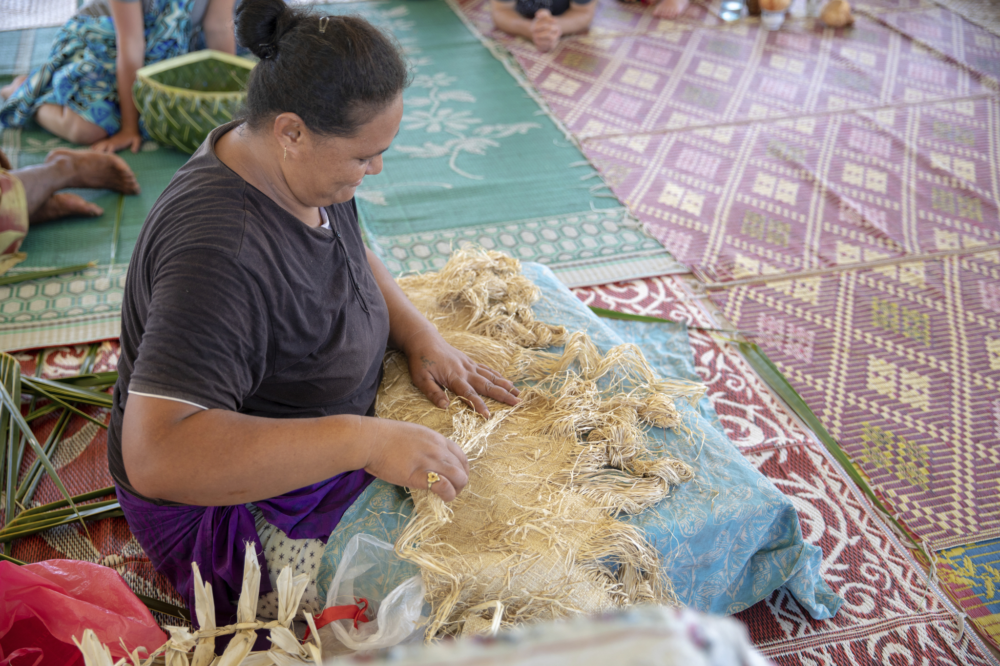 A woman weaves a fine mat in Setafao Saipipi Village, Samoa