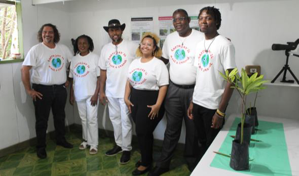 Six people in matching shirts that say "Earth Day '24: Make a Change"