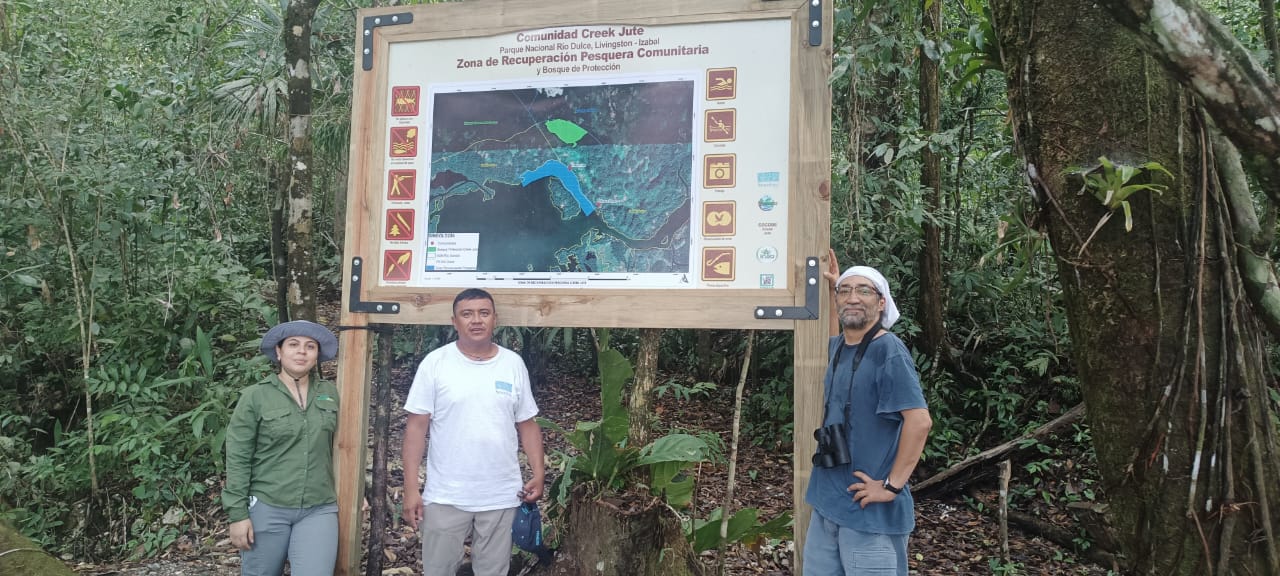 Two people stand in front of an informational sign