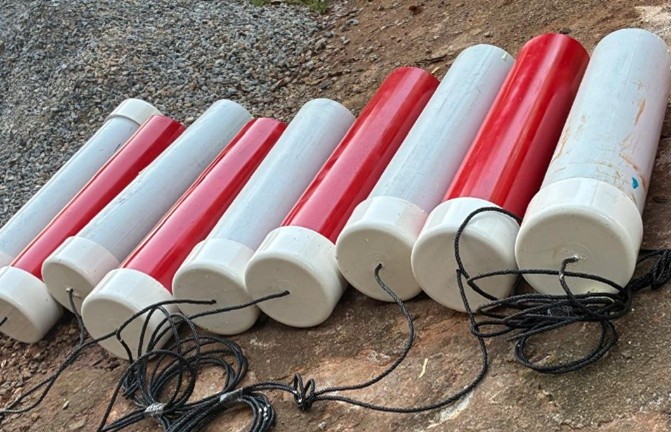 Red and white buoys on the beach