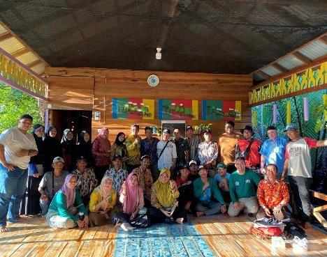 A group of people pose together in a bright, colorful room