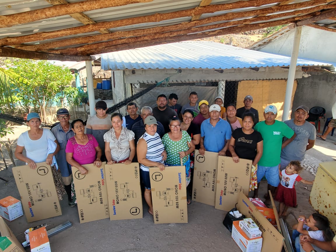 A group of people standing with large cardboard boxes