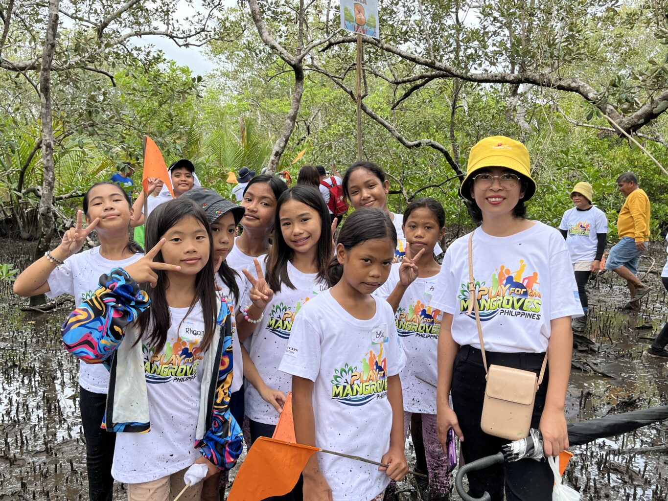 Group of kids with guide in mangrove forest