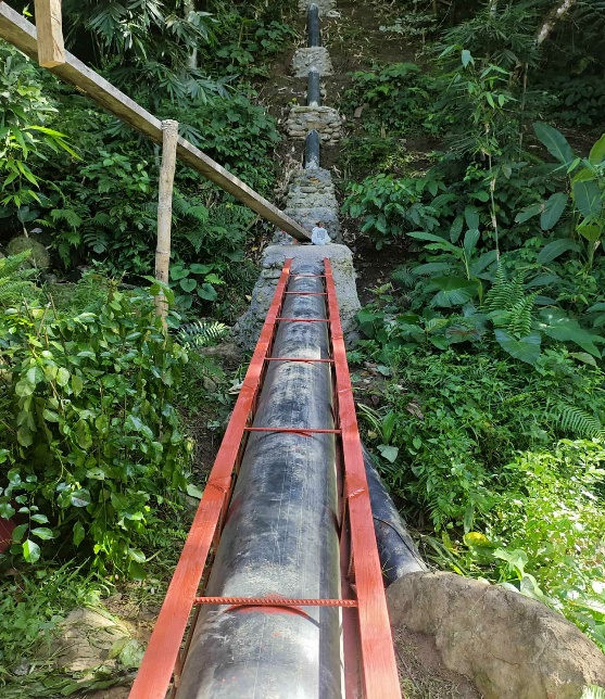 Large water pipe going up side of hill