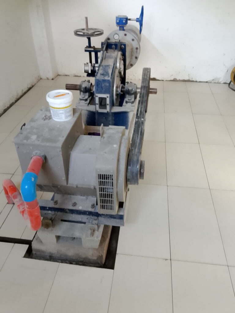 Turbine inside building with supply pipe coming through wall