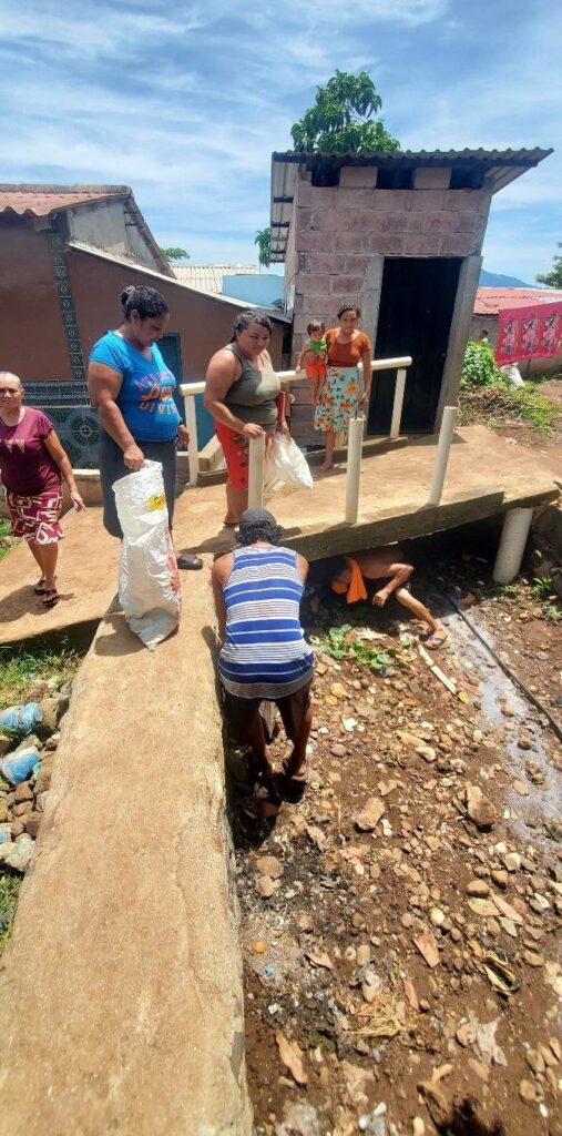 A group of people lay the foundation of a building
