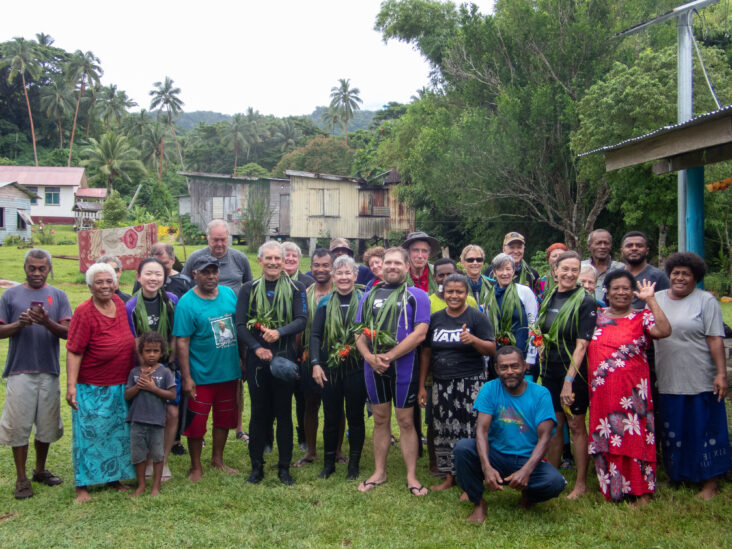 Divers and snorkelers meet with local people in a remote Fijian village