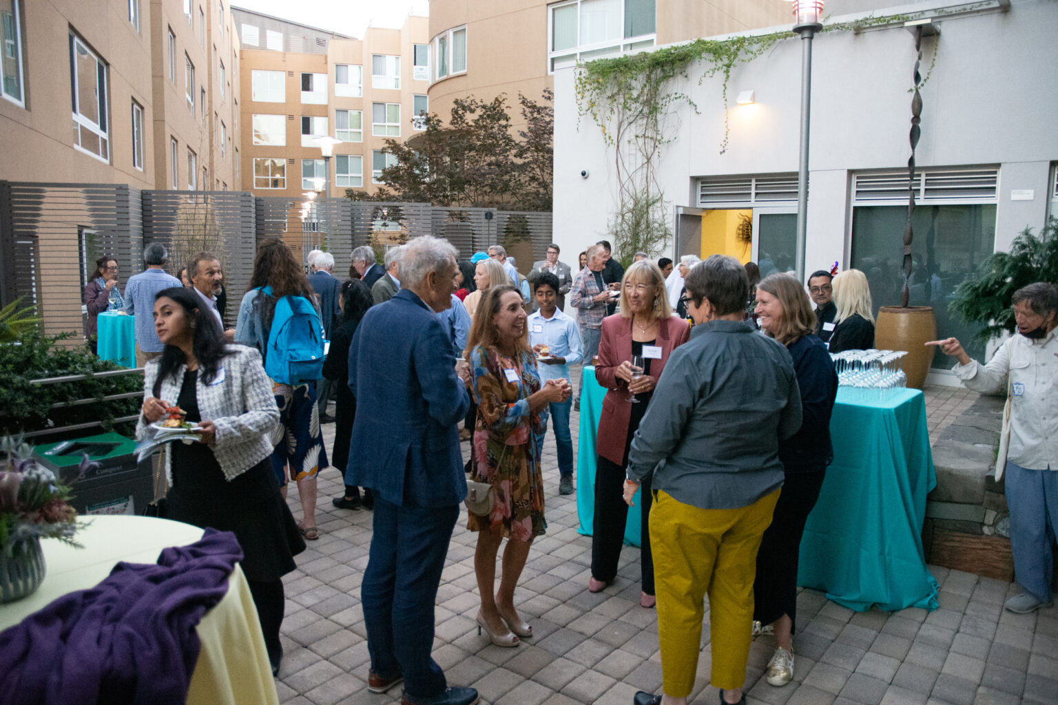 Group of people mingling on outdoor terrace