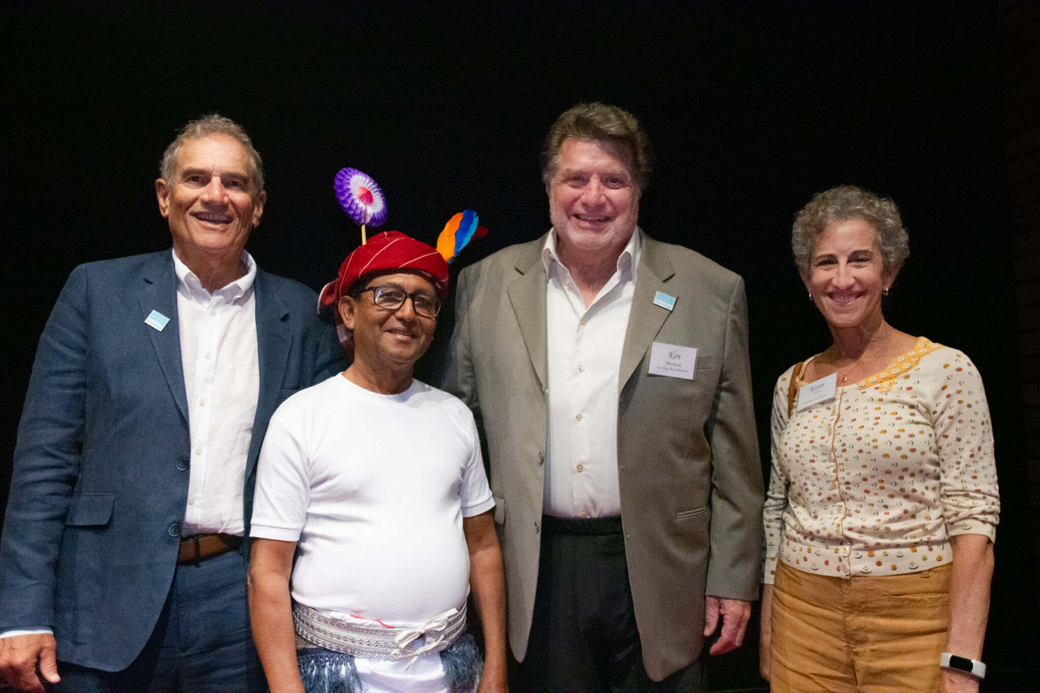 Four people pose for camera