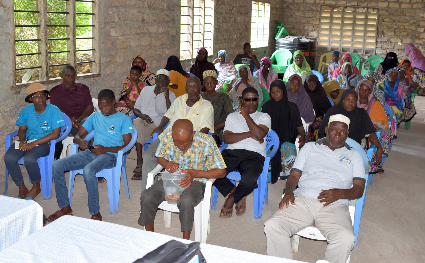 A group of people attend a meeting