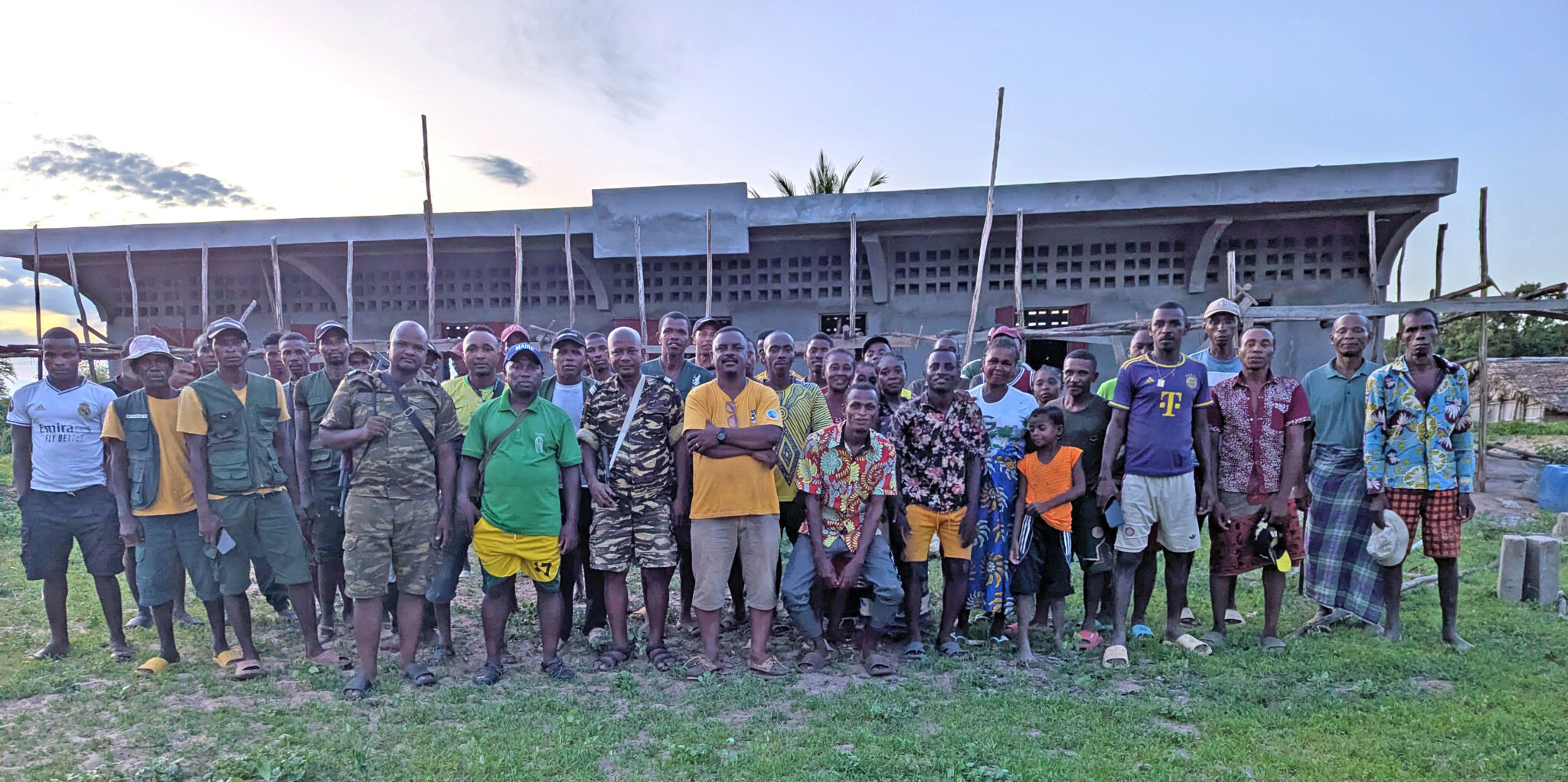 Community members stand in front of new school