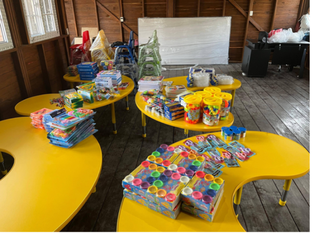 Yellow tables filled with kids' learning and art supplies