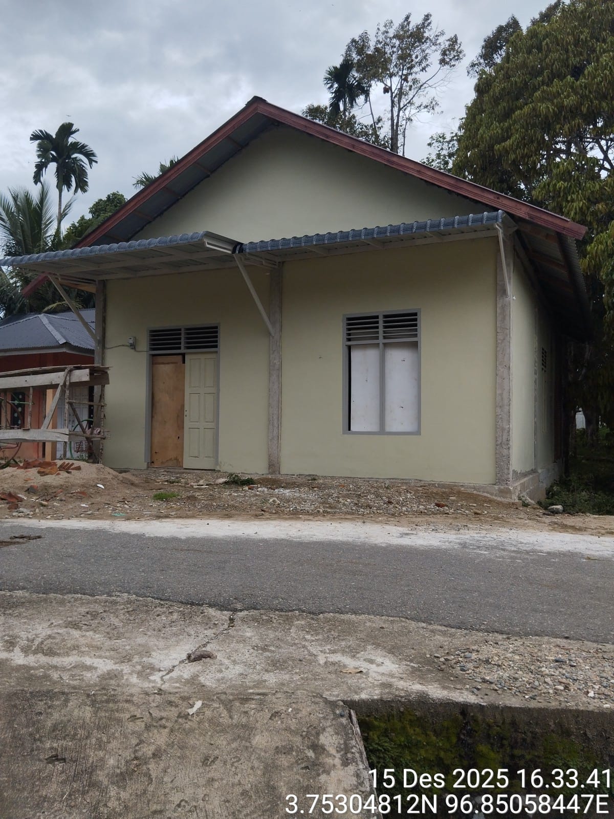 Nearly complete white building under construction, seen from front