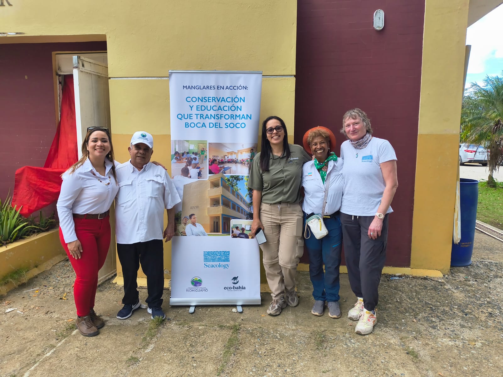 Group of people pose with banner about the project