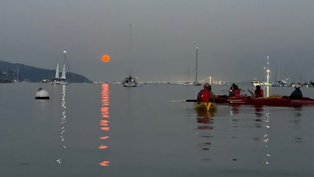 kayakers on San Francisco Bay at night