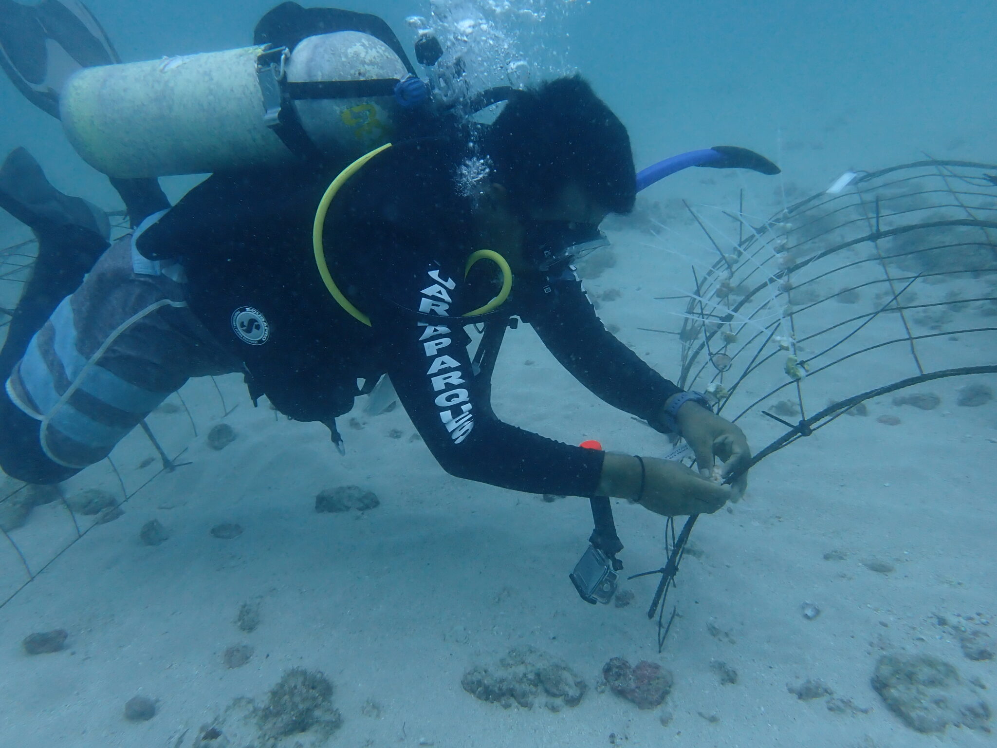 Diver works on metal frame underwater