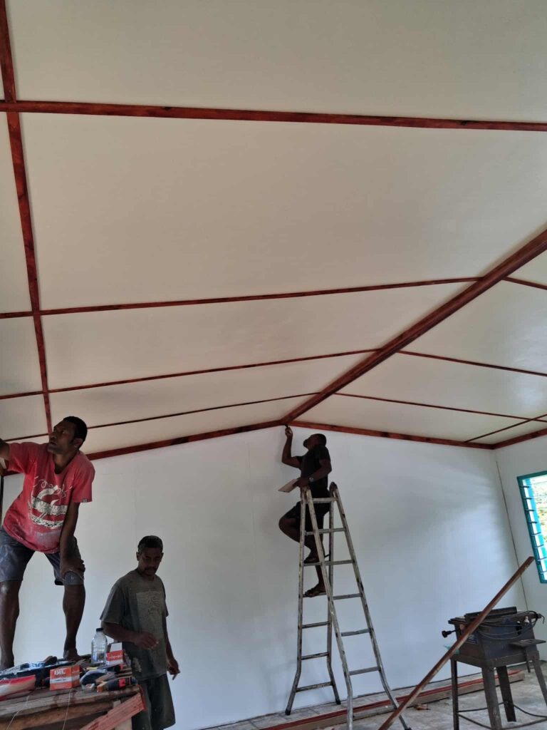 Construction workers inspect nearly finished ceiling
