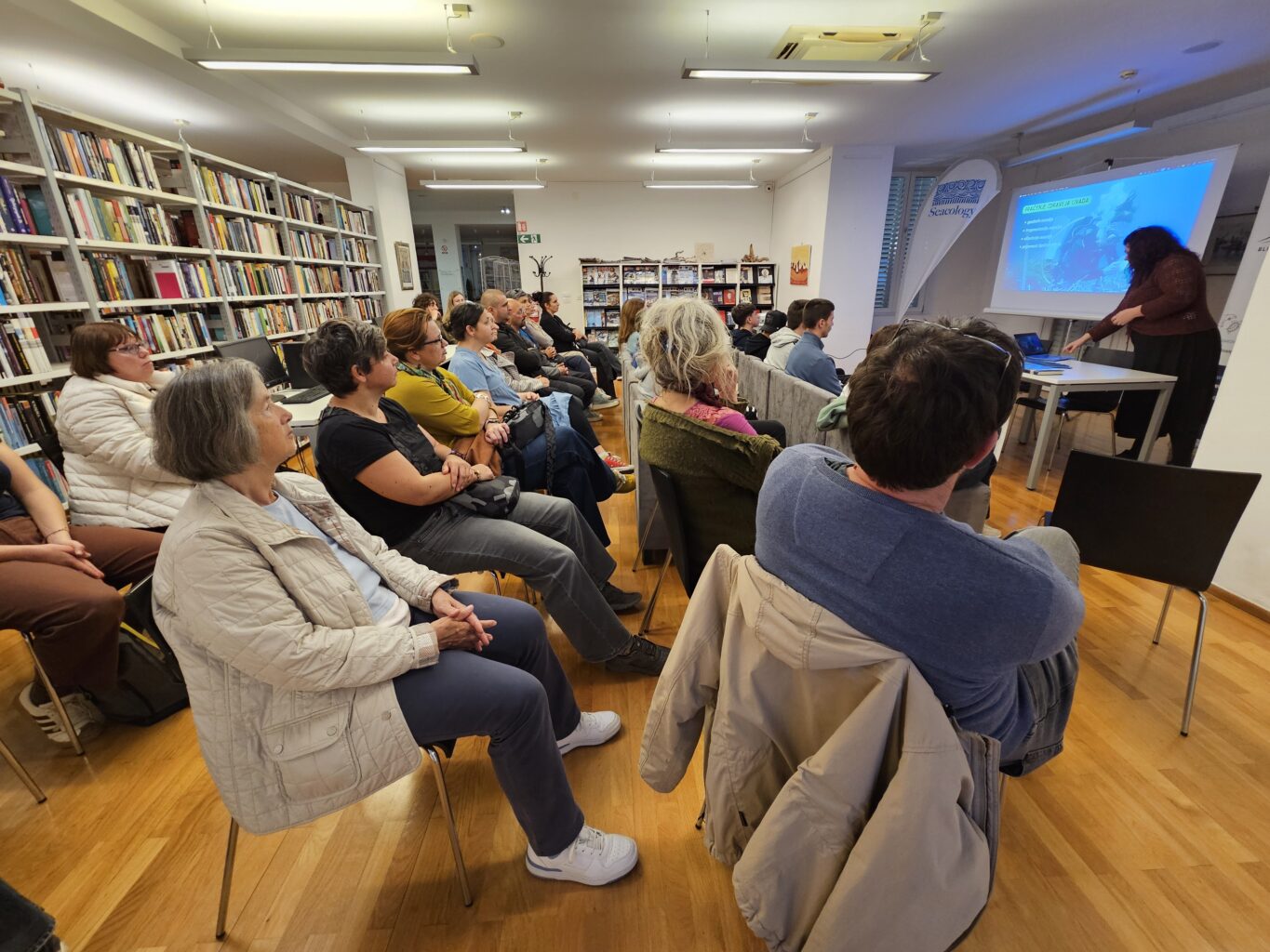 A group of people listen to a speaker