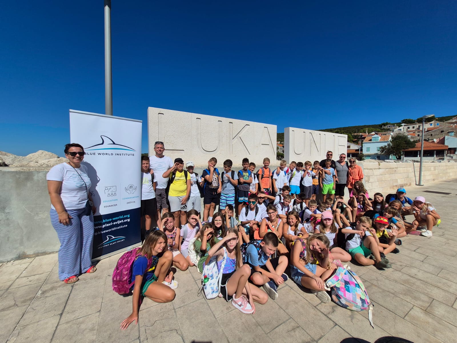 Group of kids poses for photo on sunny day