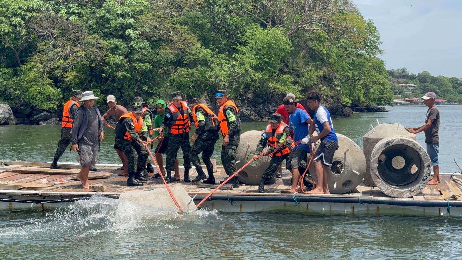 A group of people in life vests install dome structures in the water