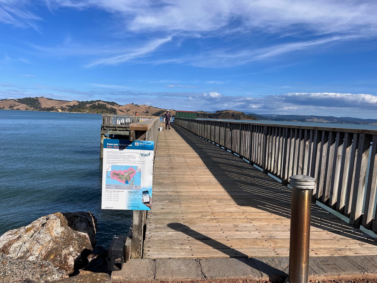 A sign about fishing rules posted on the end of a pier