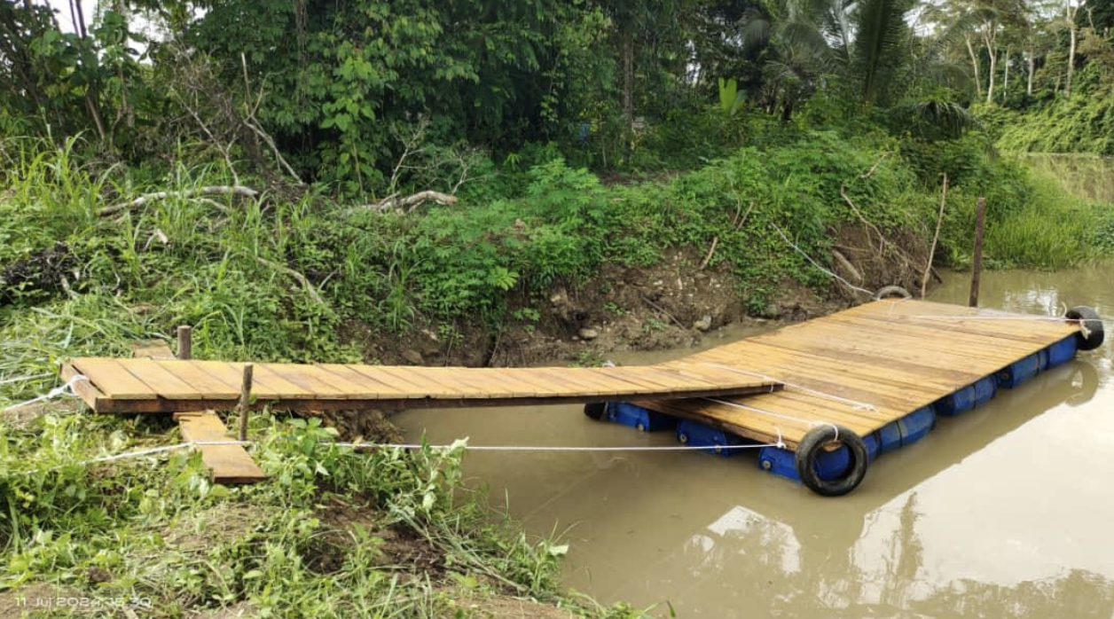 A new wooden platform floats on muddy water