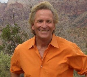 Doug McConnell with mountains and forest in background
