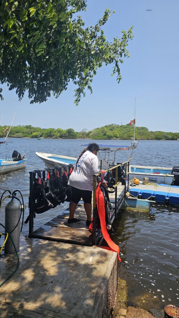 A person tying a boat up to a dock