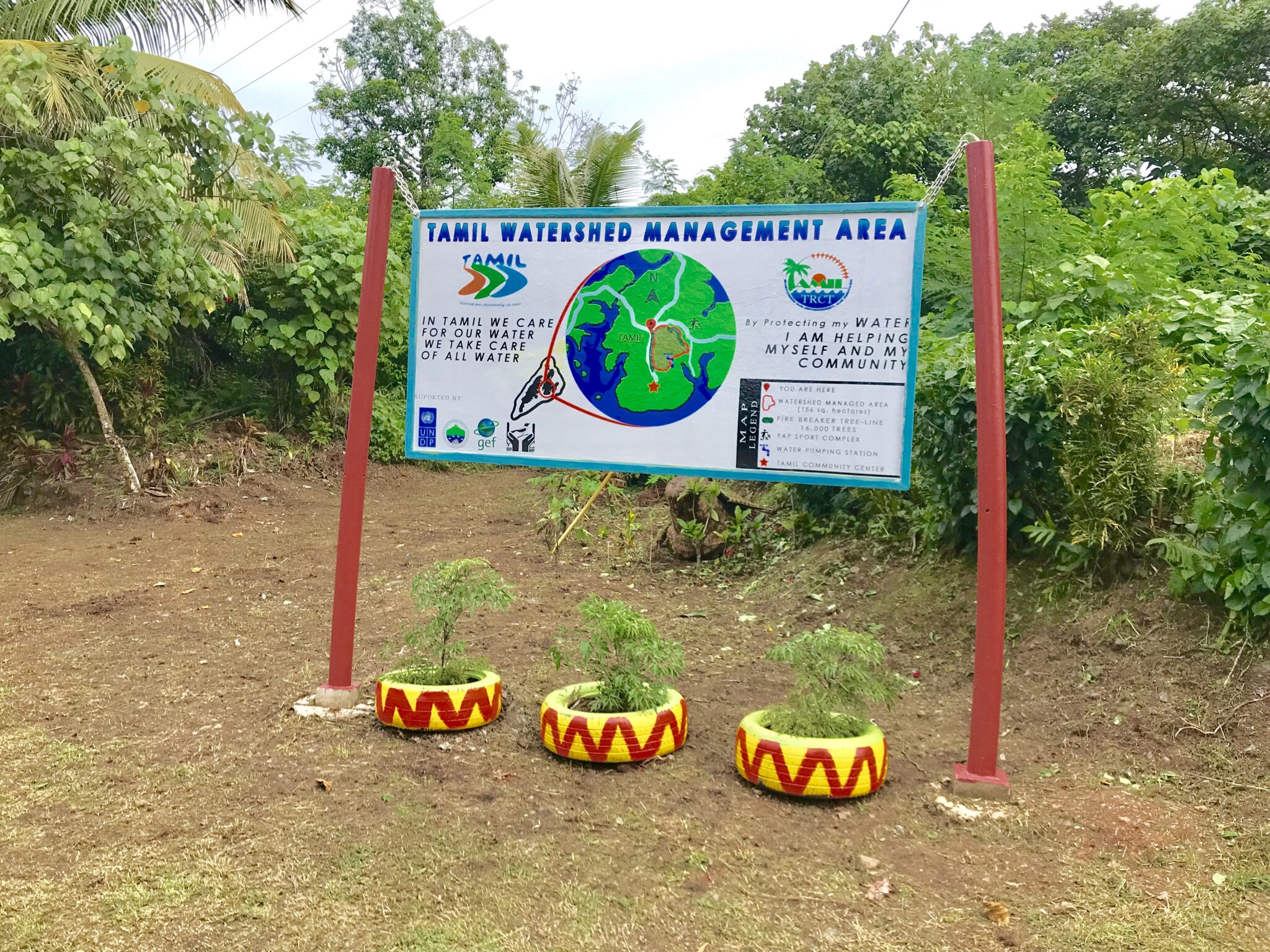 sign with forest in background