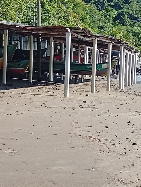 Colorful boats under protective structures on a beach