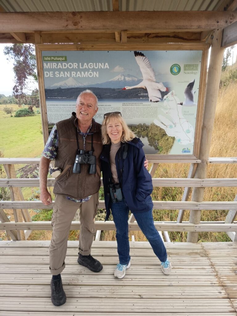 Two people stand in front of an informational sign