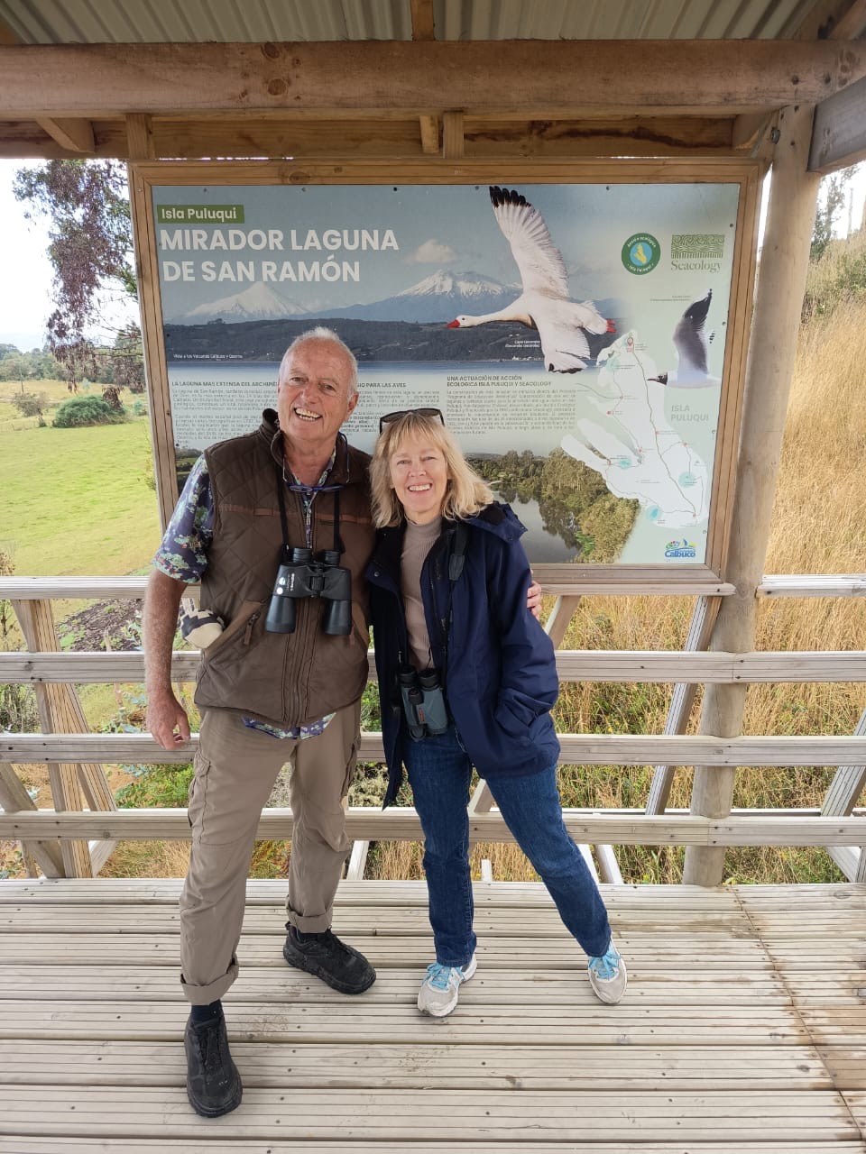 Two people stand in front of an informational sign