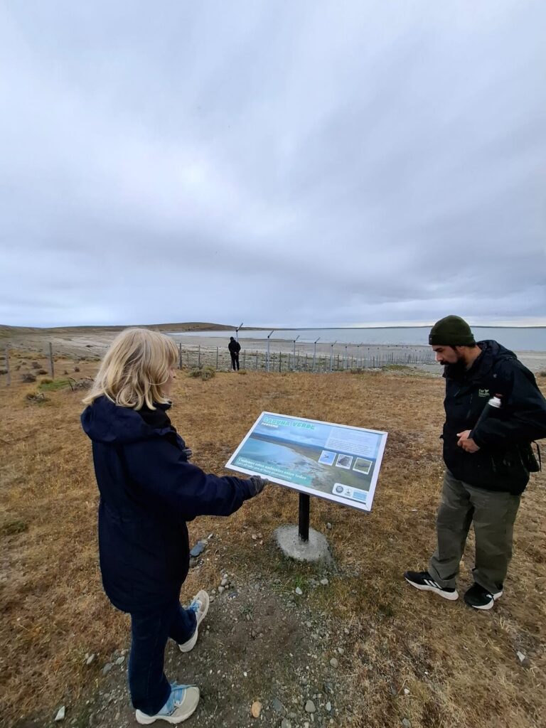 Two people look at an informational sign
