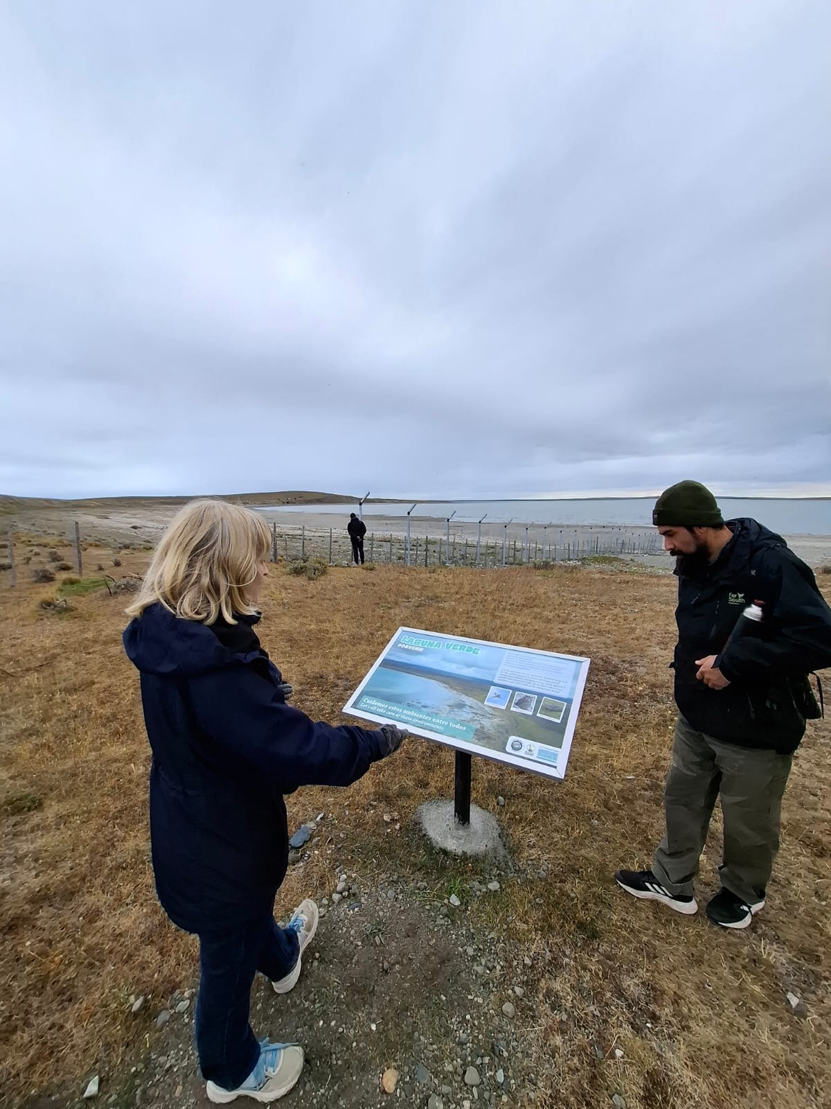 Two people look at an informational sign