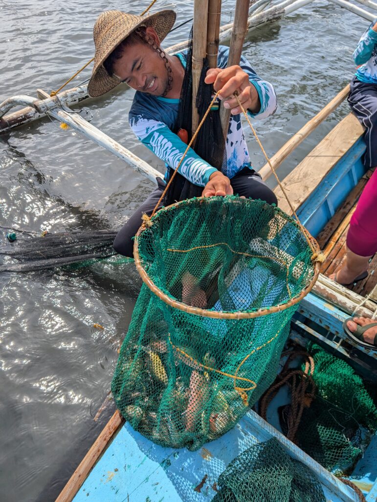 A person holding a net full of fish