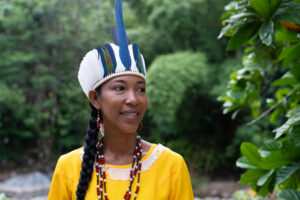 smiling young woman in headdress with river in background